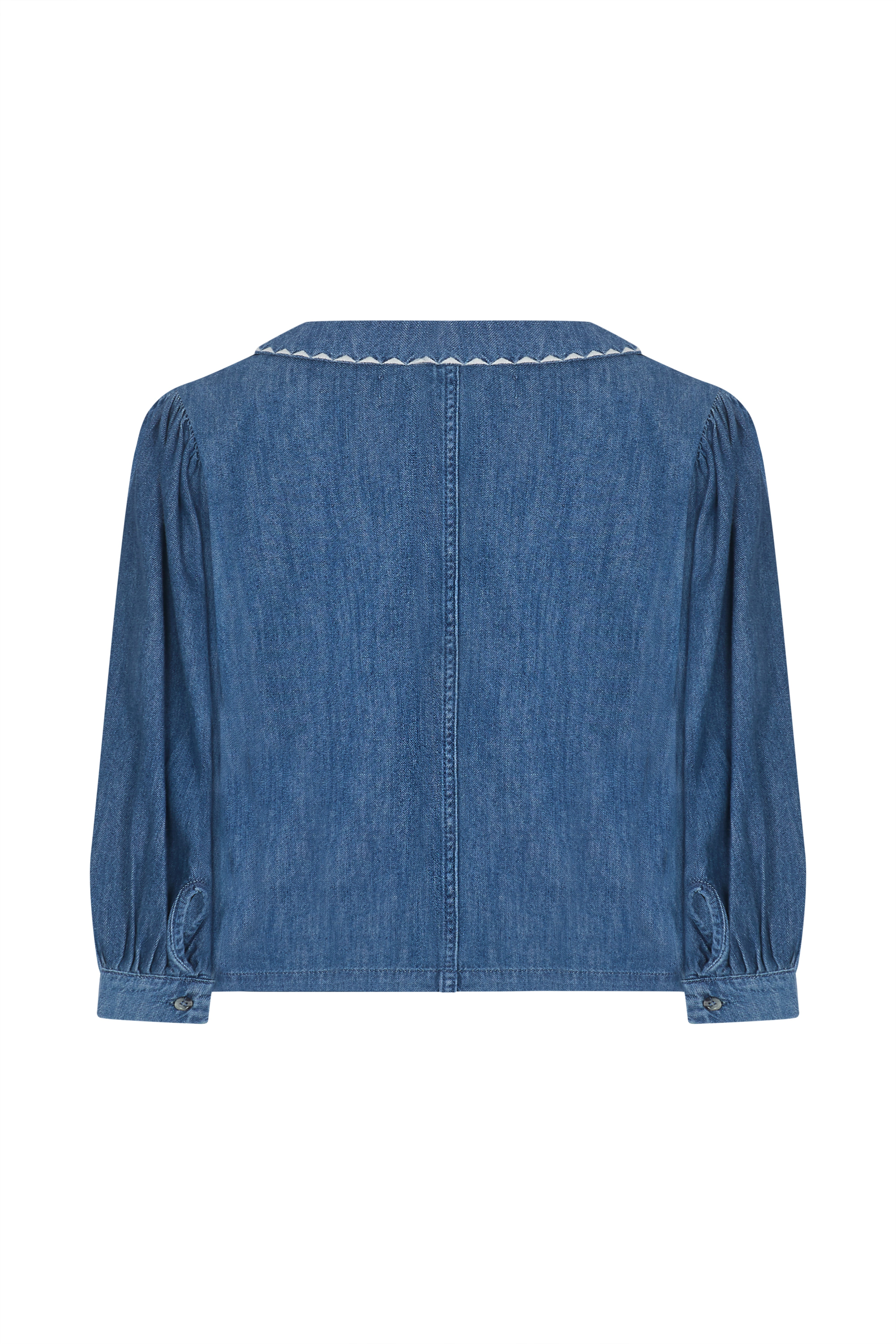 Back of a blue denim button up top with an oversized collar on a white background